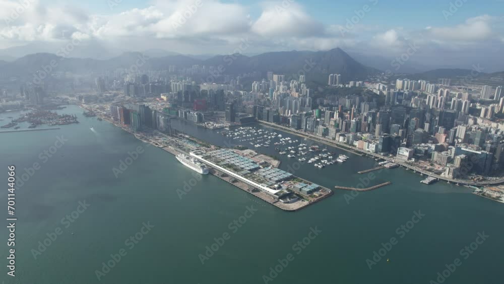 Docked Cruise Ship in Kai Tak Cruise Terminal Hong Kong city, Kwun Tong and Kowloon Bay near Victoria harbor, Aerial drone skyview Docked Cruise Ship in Kai Tak Cruise Terminal Hong Kong city, Kwun Tong and Kowloon Bay near Victoria harbor, Aerial drone skyview