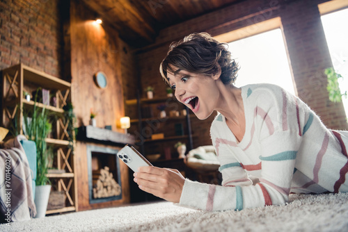 Profile photo of impressed cheerful lady open mouth use smart phone typing texting daylight house indoors photo