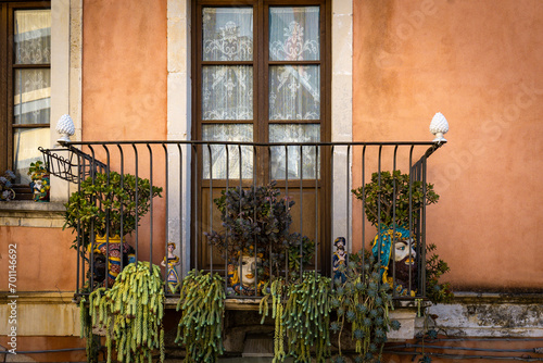 Decorated balcony with heads and succulents in Taormina on a rock terrace on the slope of Monte Tauro, Sicily, Italy photo
