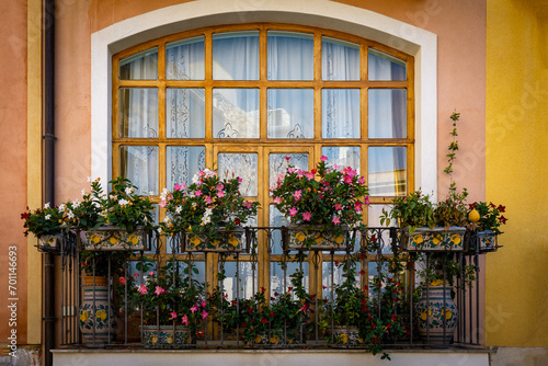 Decorated balcony with blooming potted flowers in Taormina in Sicily  Italy