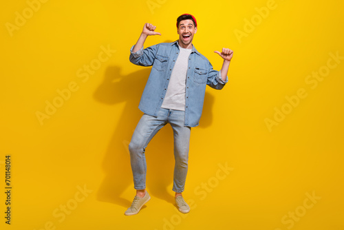 Full length photo of cool funny man dressed jeans shirt pointing thumbs himself isolated yellow color background