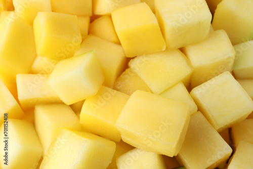 Many delicious mango cubes as background, closeup