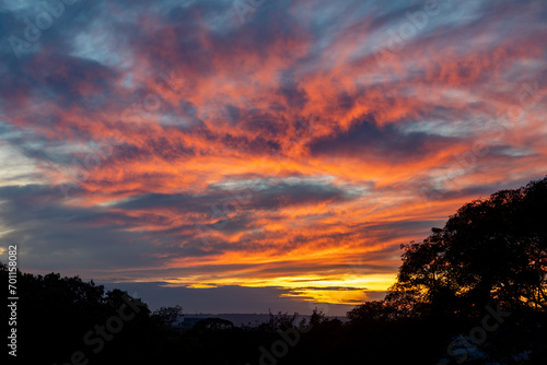 Idyllic blue sky and orange and multicolored clouds © Adilson