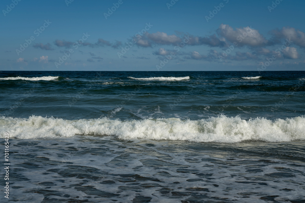 View of the incoming wave on the Baltic Sea on the shore of the Curonian Spit on a summer day, Kaliningrad region, Russia