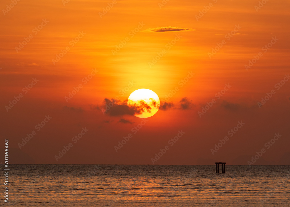 Beautiful sunrise over the sea at Saphanhin public beach, Phuket, Thailand. Beautiful sunrise over the sea at Saphanhin public beach, Phuket, Thailand.