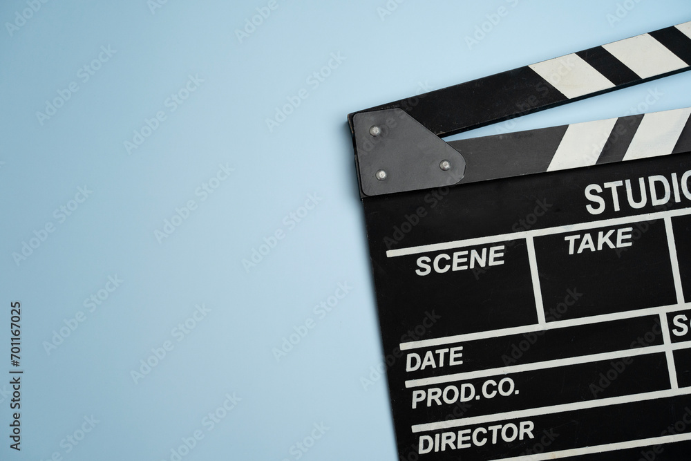 Naklejka premium movie clapper on blue table background ; film, cinema and video photography concept