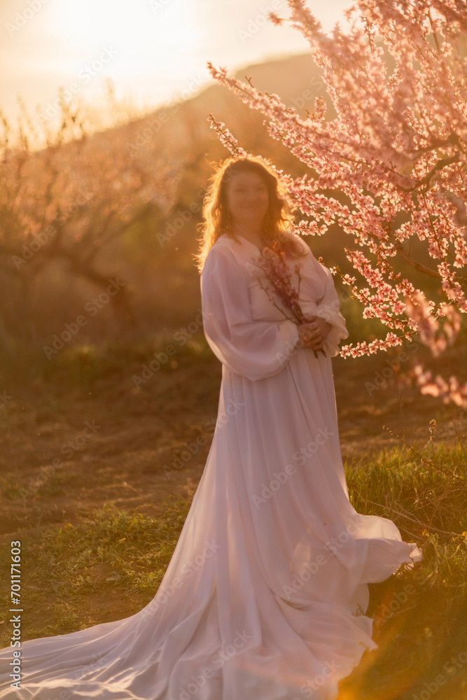 custom made wallpaper toronto digitalWoman blooming peach orchard. Against the backdrop of a picturesque peach orchard, a woman in a long white dress enjoys a peaceful walk in the park, surrounded by the beauty of nature.