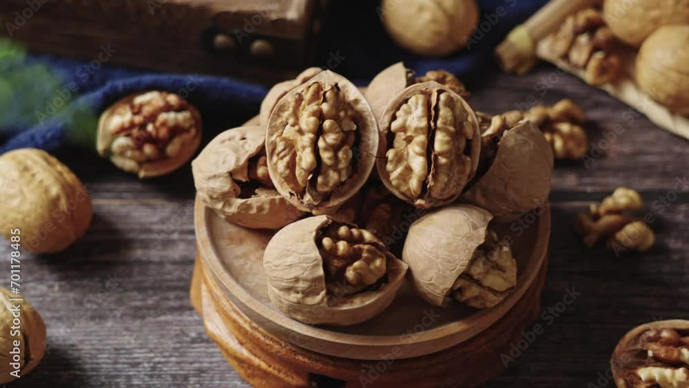 Walnuts are placed on a rustic old wooden table Walnuts are placed on a rustic old wooden table