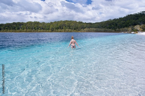 Refreshing Swim: Young Woman Enjoying Crystal Blue Waters of Lake McKenzie, Fraser Island, Australia.