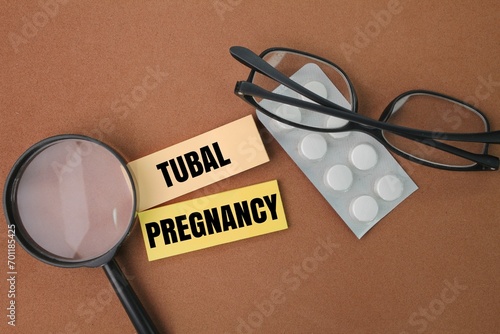 Obraz na plátne magnifying glass, glasses, medicine and colored paper with the word tubal pregna