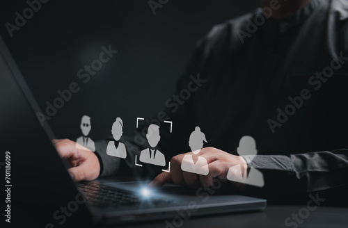 Human Resource Management or HRM concept. Businessman use computer laptop to pick human icons for human development and recruitment concepts. Search an expert specialist person to join the team. photo