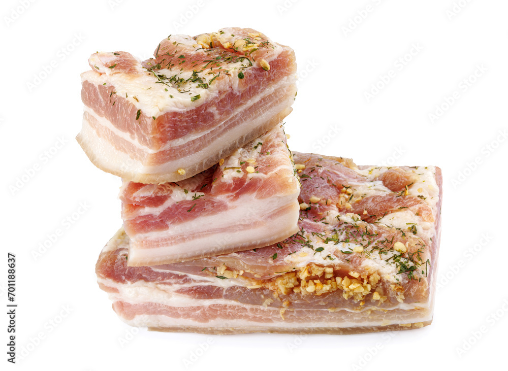 Appetizing salty lard with layers of meat with garlic and herbs. Three pieces of salted lard isolated on a white background. Appetizing salty lard with layers of meat with garlic and herbs. Three pieces of salted lard isolated on a white background.