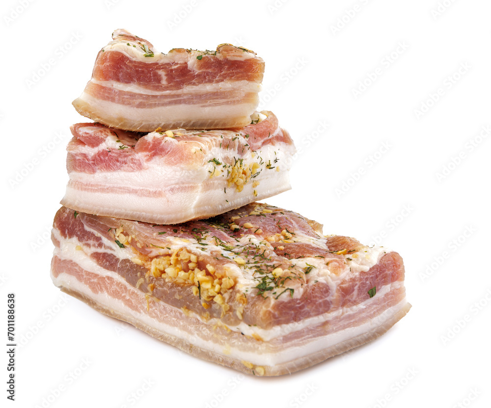 Appetizing salty lard with layers of meat with garlic and herbs. Three pieces of salted lard isolated on a white background. Appetizing salty lard with layers of meat with garlic and herbs. Three pieces of salted lard isolated on a white background.