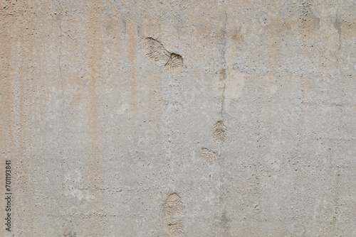 flat gray solid concrete wall with shoe soles imprints  full frame background and texture.