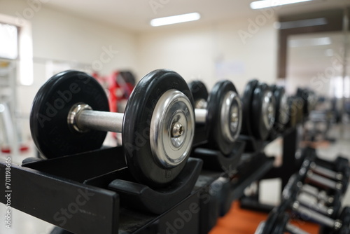 Dumbbells displayed in order of weight in a dumbbell rack