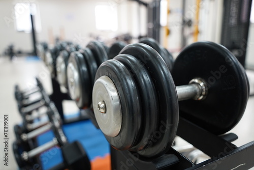 Dumbbells displayed in order of weight in a dumbbell rack