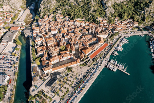 Yachts are moored off the coast of the ancient town. Kotor, Montenegro. Drone