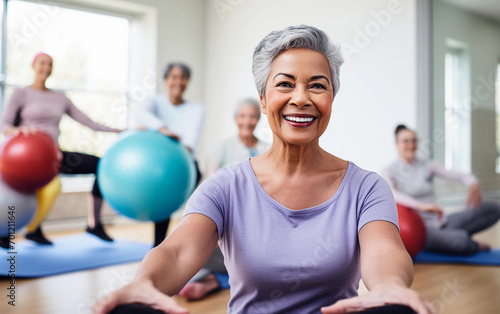 Diverse group senior people doing fitness exercises with fitball. Group of people exercising in gym