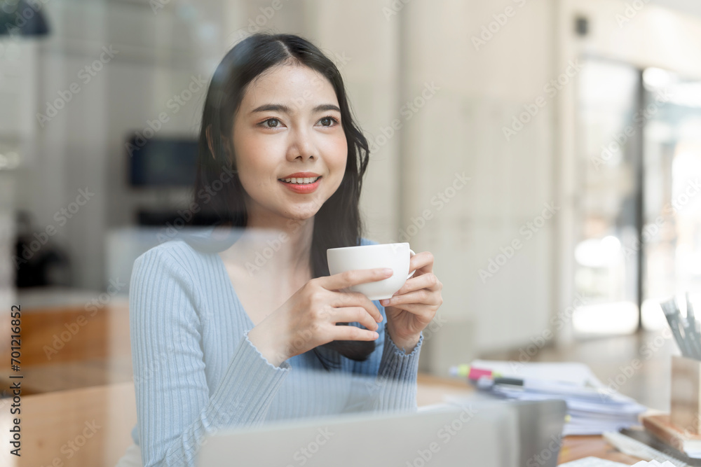 Portrait of joyful young woman enjoying a cup of coffee at home office. Portrait of joyful young woman enjoying a cup of coffee at home office.