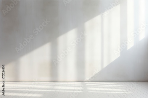 Empty white wall where sunlight shining through a window photo