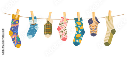 Socks clothesline with clothespins, cotton and wool socks on rope, cartoon vector. Socks hanging on laundry line with pins, socks with color ornament pattern, children colorful clothes on clothesline