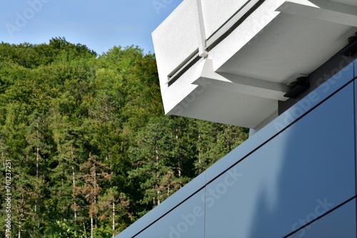Obraz na płótnie A view of the balconies of modern buildings situated near forest trees w salonie