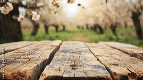 Folded wooden boards, front view against the backdrop of a spring blooming cherry orchard..