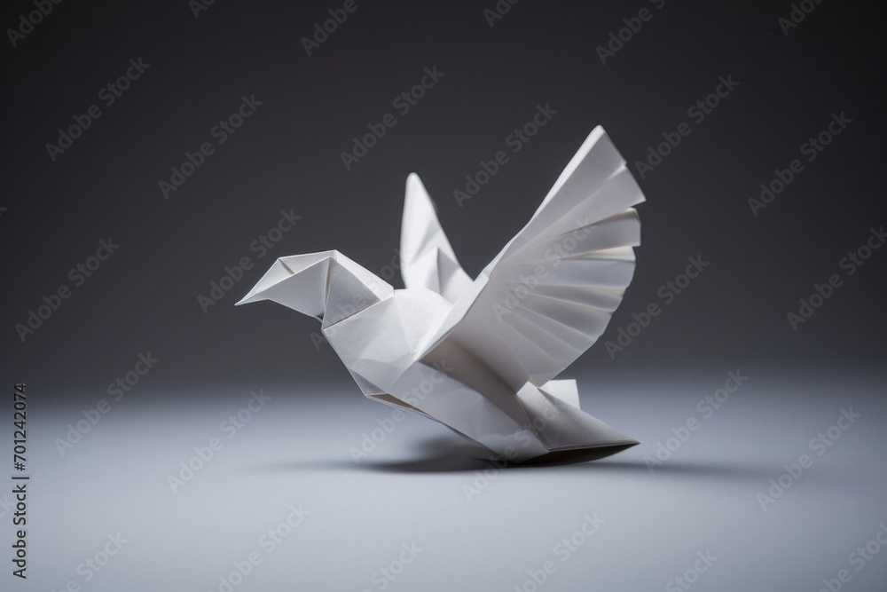 A white paper dove origami on a blank grey background. - obrazy, fototapety, plakaty 