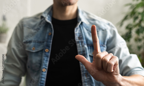Man showing gesture in sign language on white background © Angelov