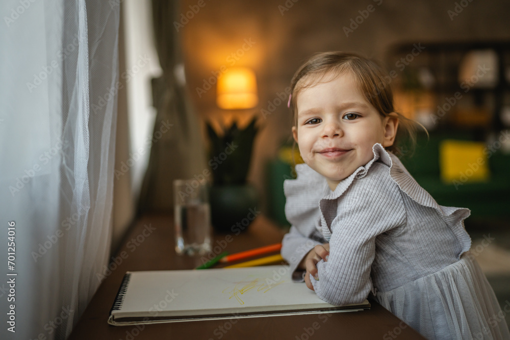 Toddler girl caucasian child play with crayons at home Toddler girl caucasian child play with crayons at home