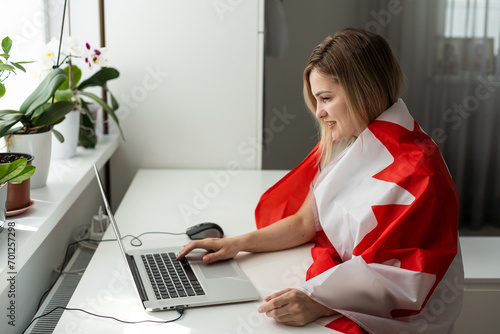 woman hands and flag of Canada on computer, laptop keyboard 