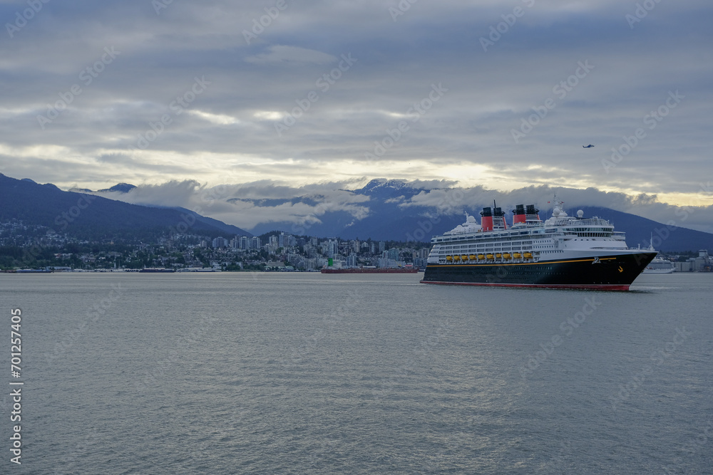 Classic modern cruiseship or cruise ship liner Magic or Wonder arrival into Vancouver cruise port in Canada for Alaska cruising on family vacation
