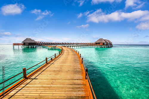 Maldives paradise island. Tropical aerial landscape, seascape long jetty pier water villas. Amazing sea sky sunny lagoon beach, tropical nature. Exotic tourism destination popular summer vacation  © icemanphotos