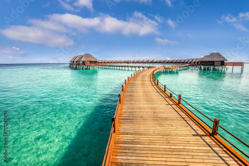 Maldives paradise island. Tropical aerial landscape, seascape long jetty pier water villas. Amazing sea sky sunny lagoon beach, tropical nature. Exotic tourism destination popular summer vacation  © icemanphotos