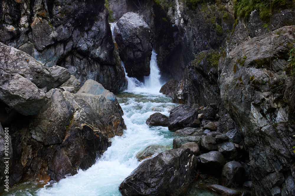 Obraz premium Waterfall on a mountain river. Summer trip.