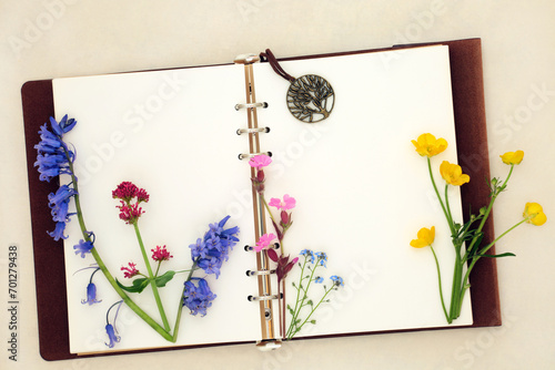 Canvas Print Spring Wildflower nature study with old leather notebook, bluebell, buttercup, red campion, valerian, forget me not, herb robert and chive blossom flowers