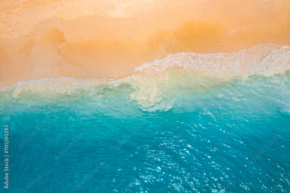 Relaxing aerial beach scene, summer vacation holiday. Blue waves surf crash amazing ocean lagoon sea sandy shore coastline. Tranquil aerial drone top view. Peaceful bright beachfront seaside landscape