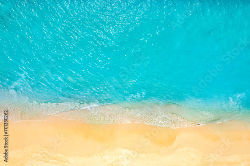 Relaxing aerial beach scene, summer vacation holiday. Blue waves surf crash amazing ocean lagoon sea sandy shore coastline. Tranquil aerial drone top view. Peaceful bright beachfront seaside landscape