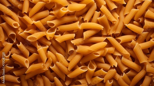 Penne pasta background. Texture top view. Food preparation. Uncooked whole grain pasta.