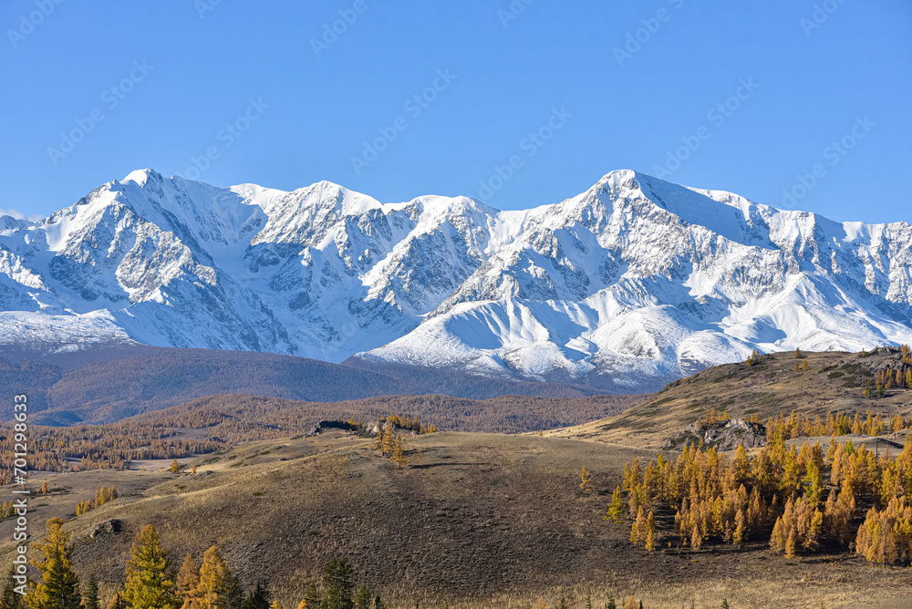Mountain landscape. Mountain peaks covered with snow in autumn.