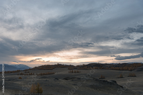 Mountain landscape. Mountainous area with yellow trees in autumn during sunrise.