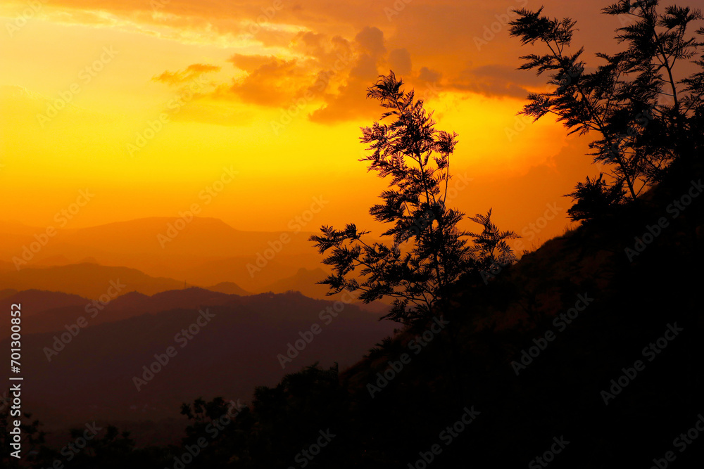 beautiful golden evening sky with mountain and trees in kerala
