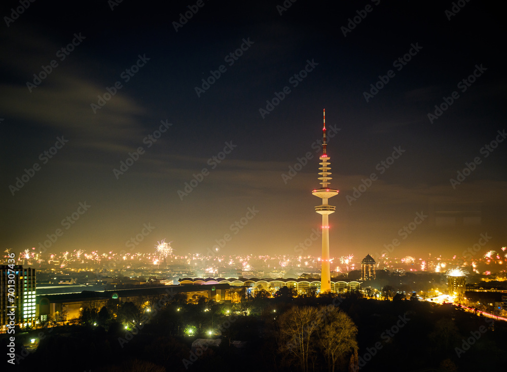 Fototapeta premium New Years Eve fireworks panoramic view over Hamburg city in Germany January 2024, rocket fireworks in the night, city lights.