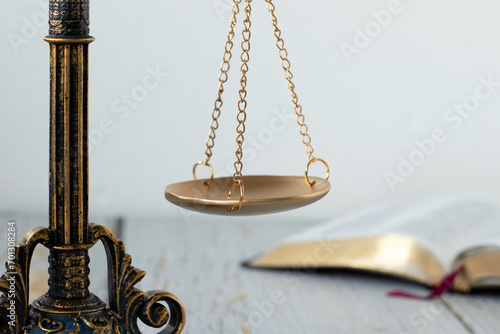 Billede på lærred Close-up of ancient scales of justice and open holy bible book with white background