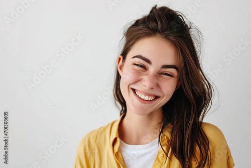asian woman winking to camera smiling joyful standing white wall photo
