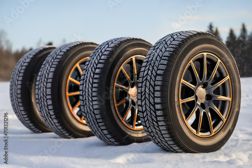 a car wheels on the background of a winter snow-covered forest, beautiful landscape, a concept of traffic safety on a slippery road © soleg