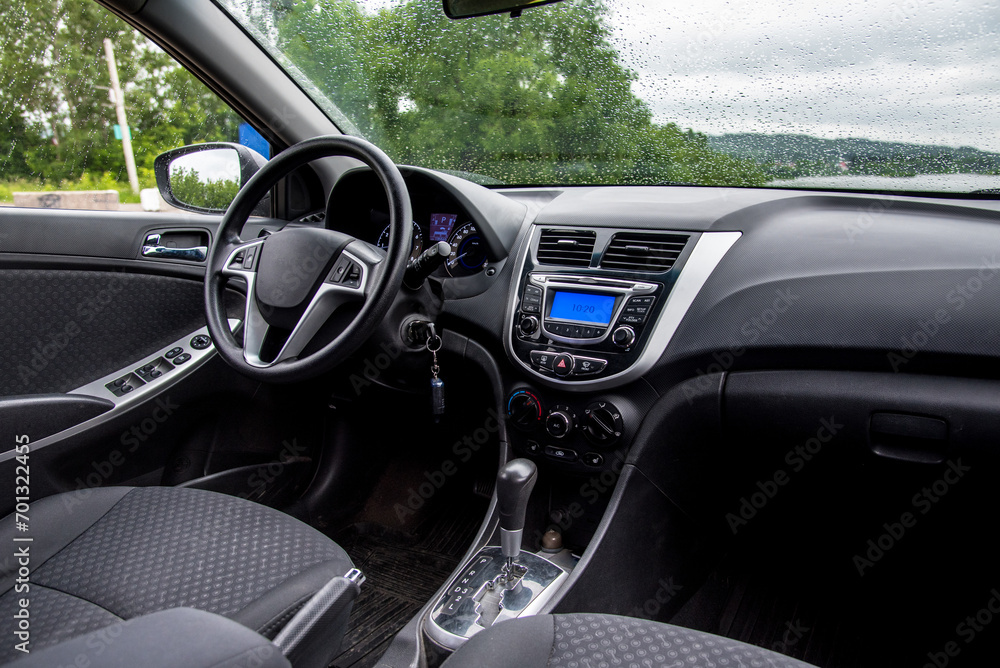 Car interior: dashboard, multimedia, steering wheel.