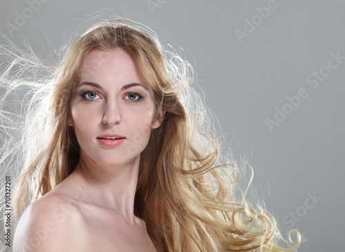 Young woman with blond fluttering hair