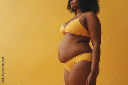 Plus-Size Model in Mustard Lingerie Against Vibrant Yellow Background, Empowered Beauty