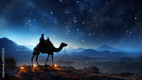 Silhouette of two wise men riding a camel along the stars in the desert